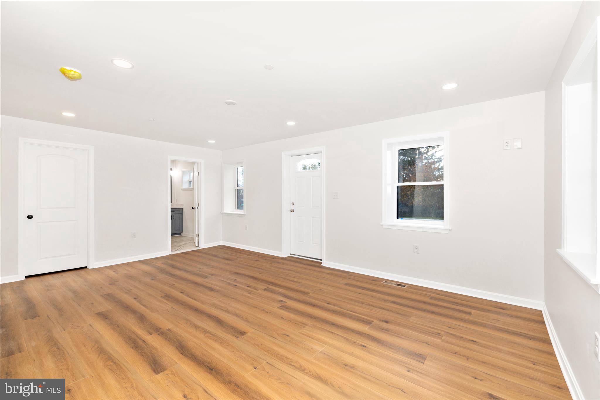 10910 Liberty Road Frederick, MD 21701 - Photo 23 of 51 a view of an empty room with wooden floor and a window