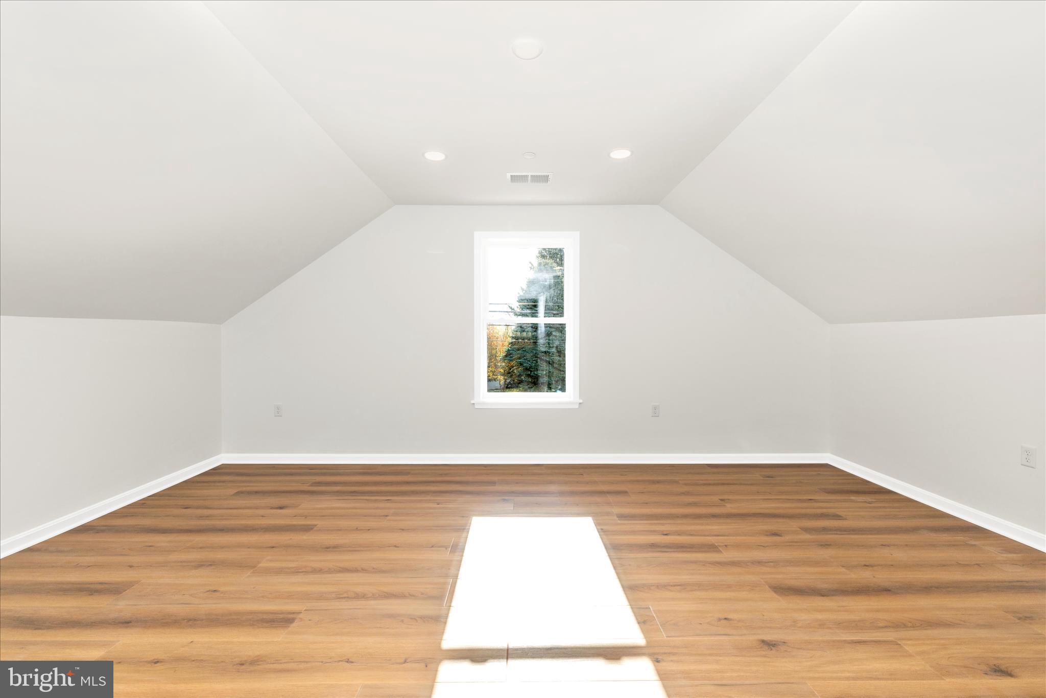 10910 Liberty Road Frederick, MD 21701 - Photo 27 of 51 an empty room with wooden floor and windows