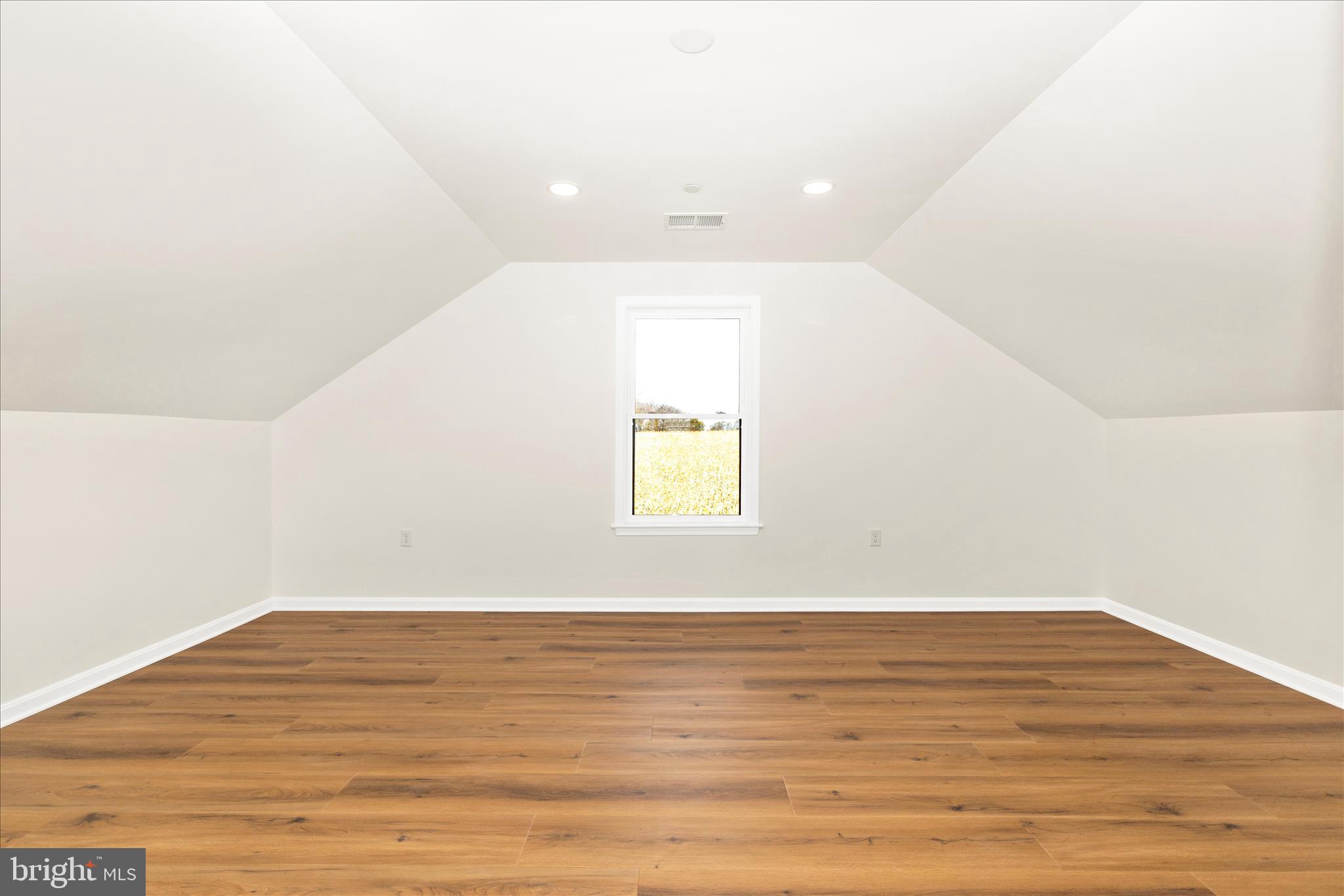 10910 Liberty Road Frederick, MD 21701 - Photo 31 of 51 a view of an empty room with wooden floor and a window
