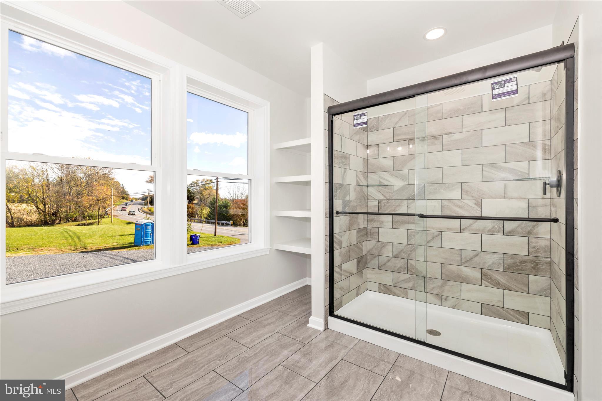 10910 Liberty Road Frederick, MD 21701 - Photo 35 of 51 a bathroom with a bathtub and a large window