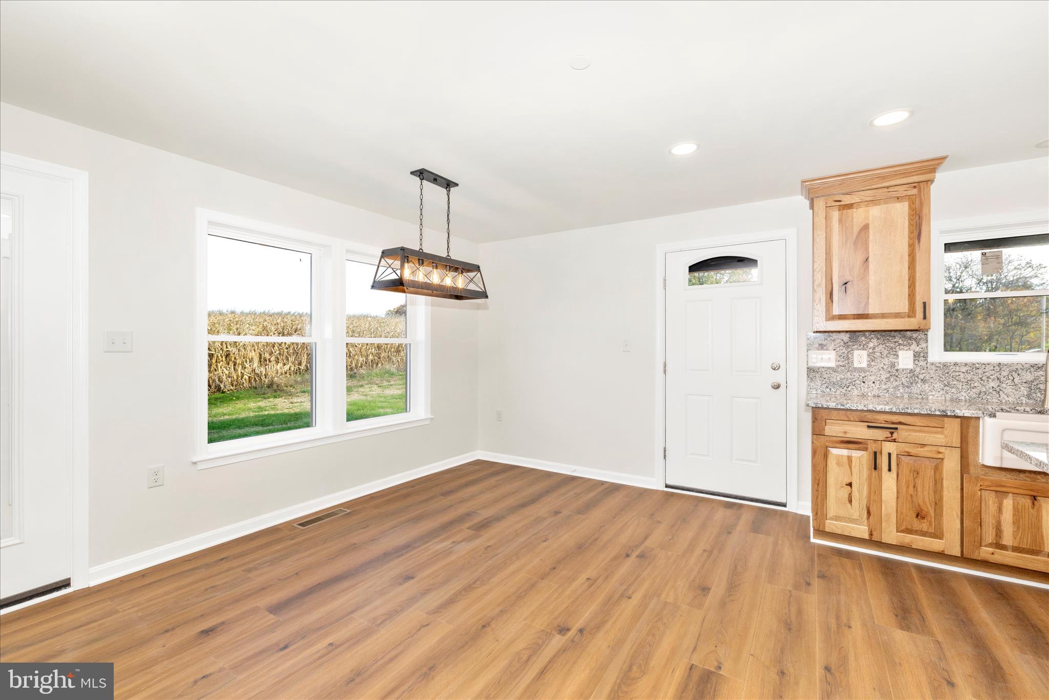 10910 Liberty Road Frederick, MD 21701 - Photo 6 of 51 a view of an empty room with a window and wooden floor