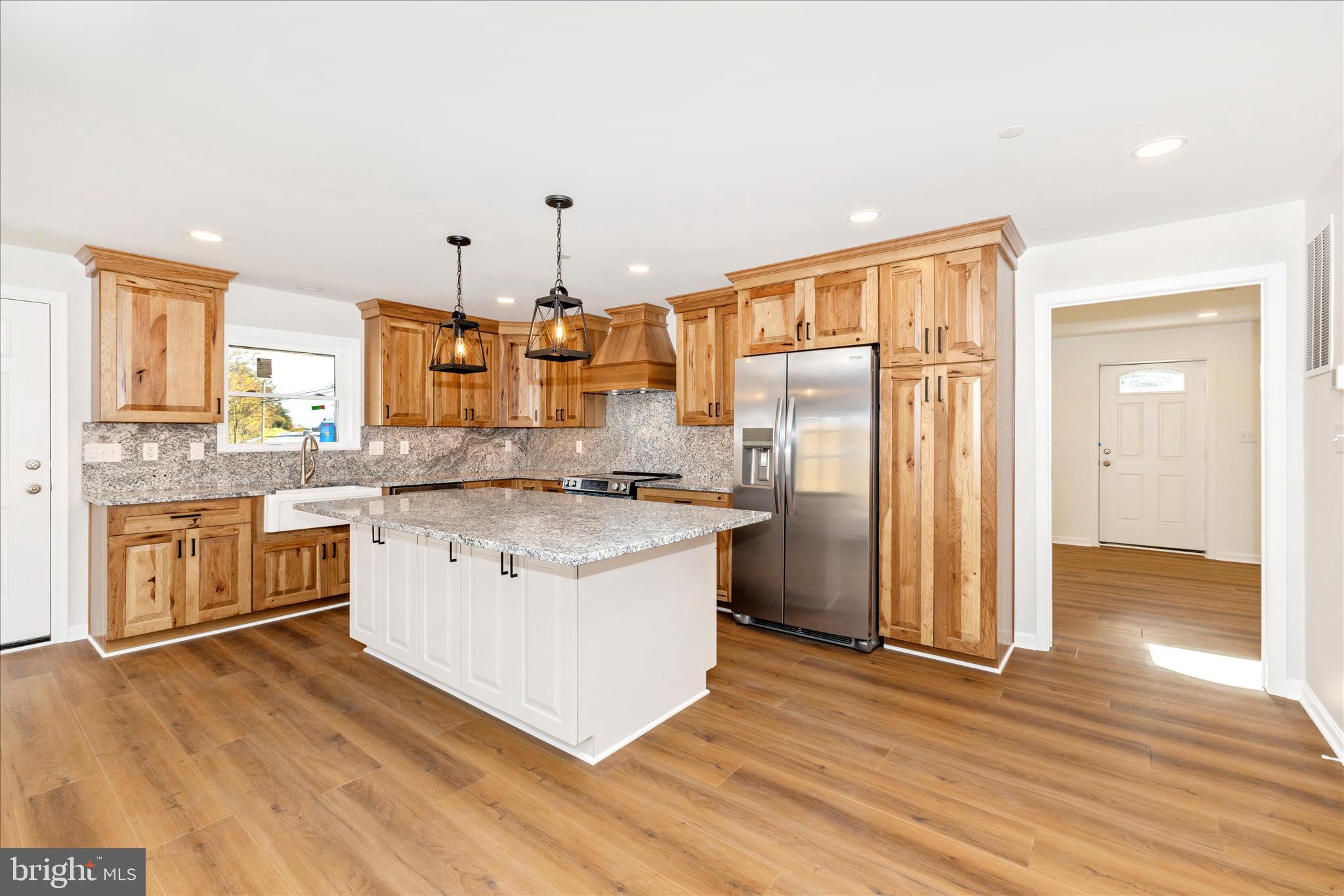 10910 Liberty Road Frederick, MD 21701 - Photo 10 of 51 a kitchen with stainless steel appliances granite countertop a sink stove and refrigerator