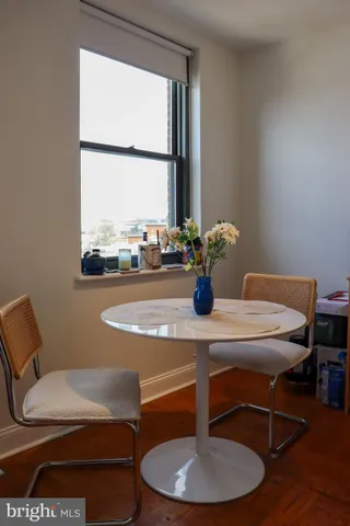 a dining room with furniture and window