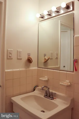 a bathroom with a sink and mirror