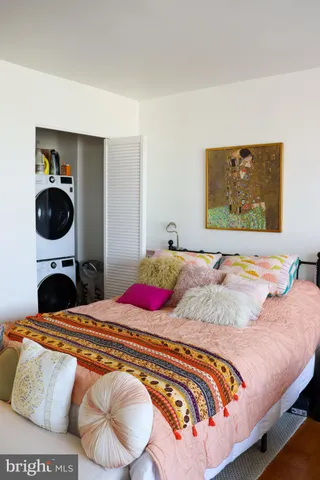 a bedroom with a bed and cabinets