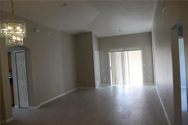 a view of a room with wooden floor and windows
