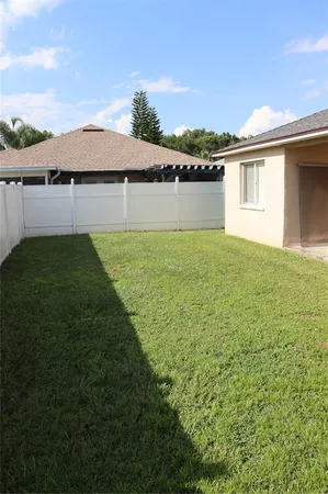 a view of a backyard with plants and lake view