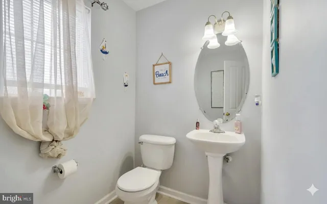 a bathroom with a sink a mirror a toilet and vanity