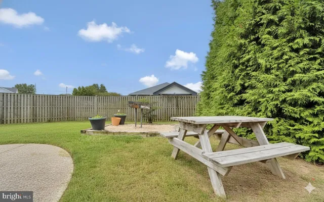 a view of backyard with deck and seating space