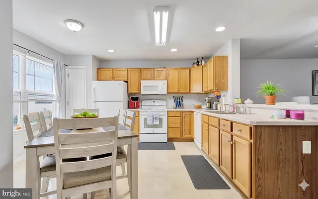a kitchen with cabinets appliances and a counter
