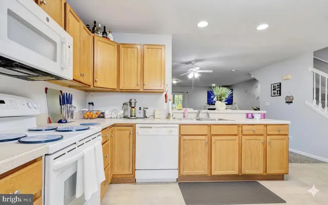 a kitchen that has a sink and a stove in it