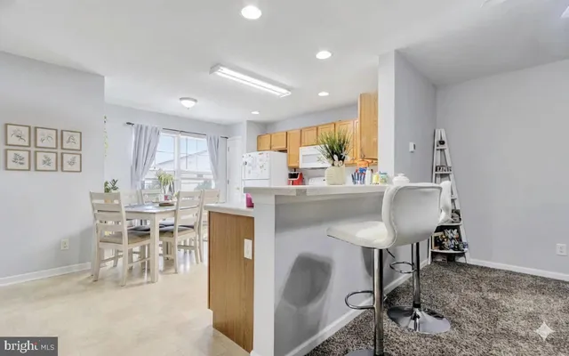 a dining room with furniture and a large window