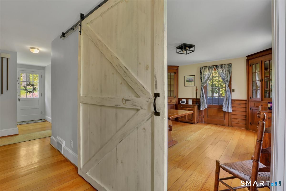 292 Parmelee Hill Road Durham, CT 06422 - Photo 19 of 39 A barn door offers easy access and privacy in the dining room (currently used as a home office).