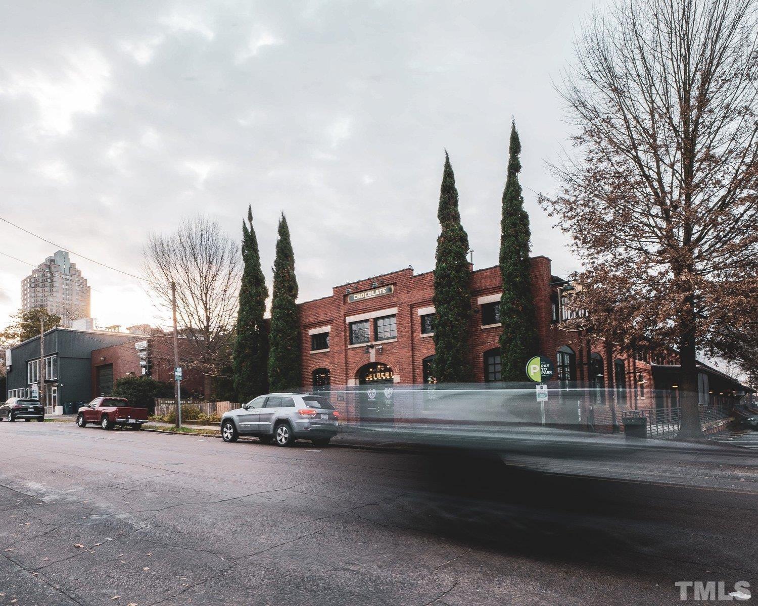 613 South West Street Raleigh, NC 27601 - Photo 12 of 18 a city street lined with buildings and trees