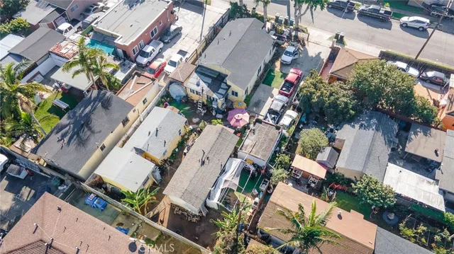 an aerial view of a house with a yard and outdoor seating