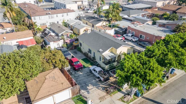 an aerial view of a house with a yard and fountain