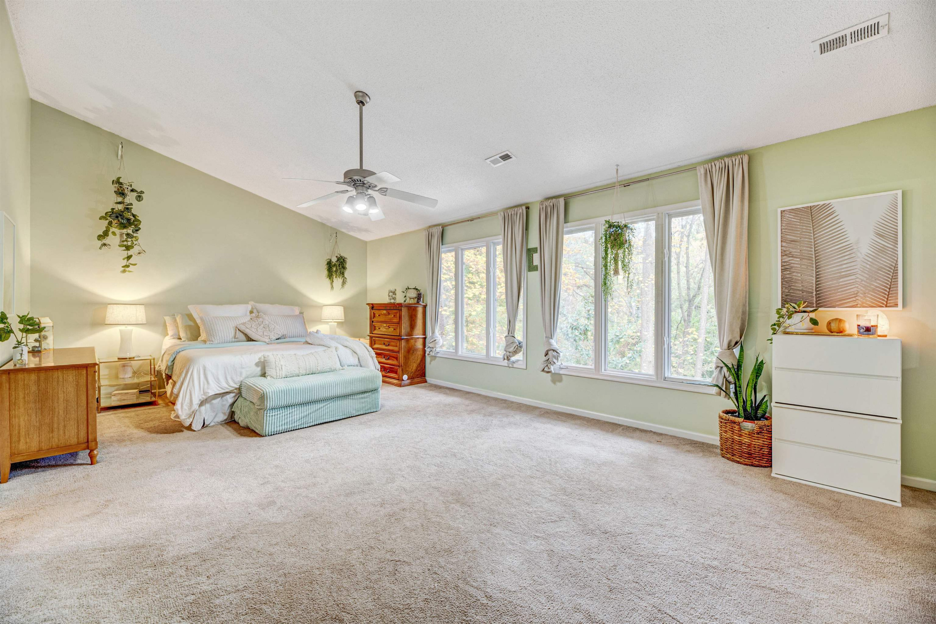 2909 Rue Sans Famille Raleigh, NC 27607 - Photo 20 of 35 a spacious bedroom with a bed and a chandelier