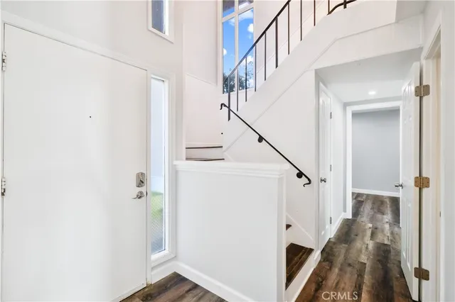 a view of entryway with wooden floor and stairs
