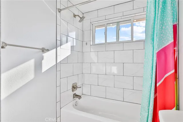 a bathroom with a bathtub and shower