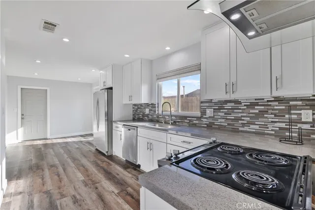 a kitchen with a stove a sink and a refrigerator