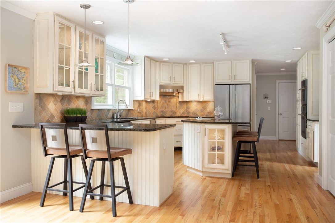 9 Cedar Meadows Road Charlestown, RI 02813 - Photo 15 of 39 Beautiful tile backsplash & granite counters are illuminated by the under cabinets lights and lighted glass cabinets!!