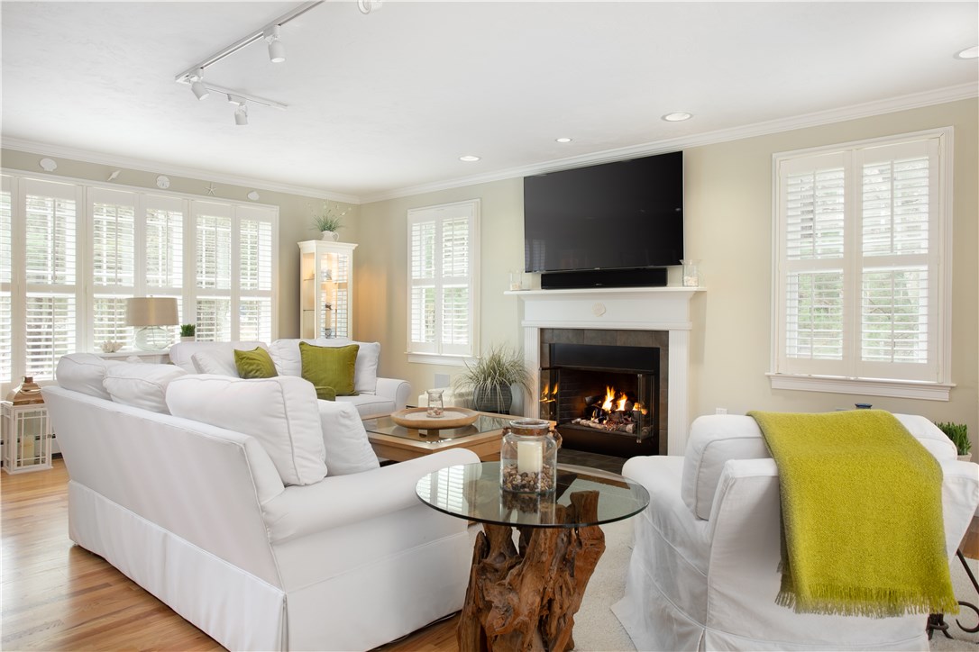 9 Cedar Meadows Road Charlestown, RI 02813 - Photo 9 of 39 Beautiful family room with recessed lights, gas fireplace, surround sound, hardwood floors and coastal white window shutters!