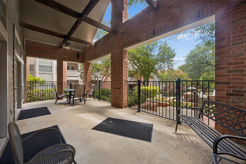 12660 Hillcrest Road, Unit 7205 Dallas, TX 75230 - Photo 21 of 25 Expansive covered patio featuring brick walls and exposed wood beams