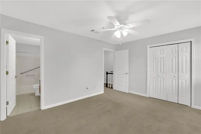 a view of an empty room with a ceiling fan