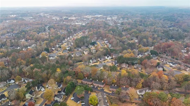 an aerial view of house with yard and mountain view in back
