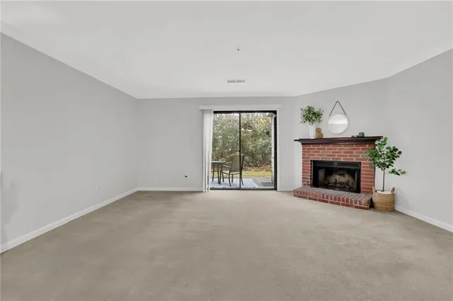a view of empty room with a fireplace