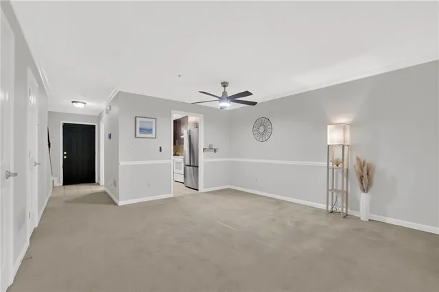 an empty room with fan and windows