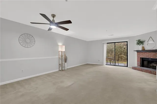 a view of an empty room with a fireplace