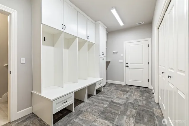 a bathroom with a double vanity sink a toilet and a shower