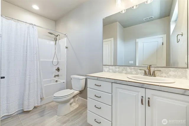 a large kitchen with stainless steel appliances granite countertop a stove a sink dishwasher and a refrigerator