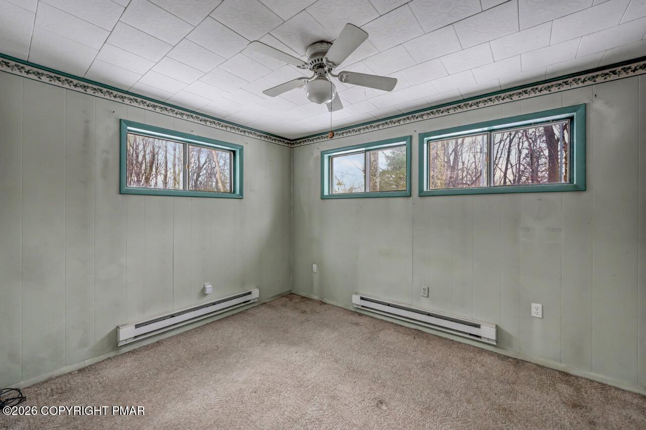 1912 Johns Road Effort, PA 18330 - Photo 31 of 44 an empty room with windows and ceiling fan