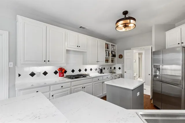 a kitchen with cabinets a sink dishwasher and a refrigerator