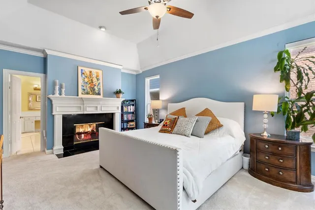 a bedroom with a bed and a fireplace