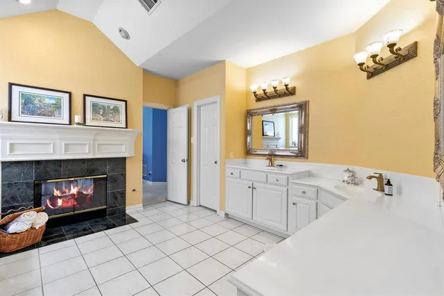 a spacious bathroom with a sink and a mirror