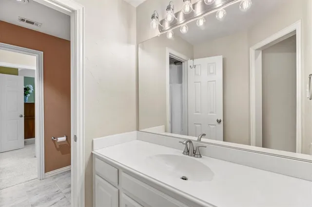 a bathroom with a sink a mirror and a shower