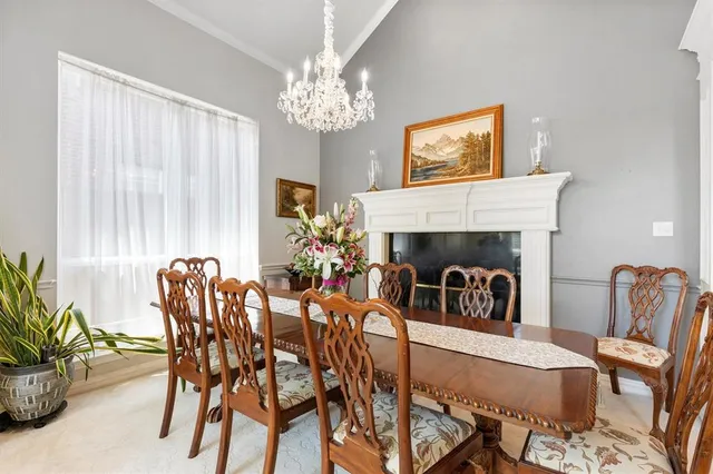a view of a dining room with furniture and a chandelier