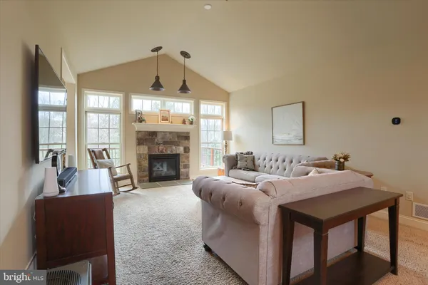 a kitchen with stainless steel appliances granite countertop a stove top oven a sink and a refrigerator