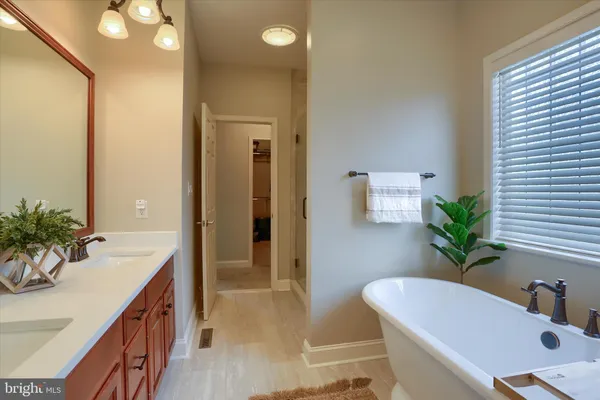 a spacious bedroom with a bed and a large window