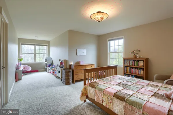 a room with pool table and windows