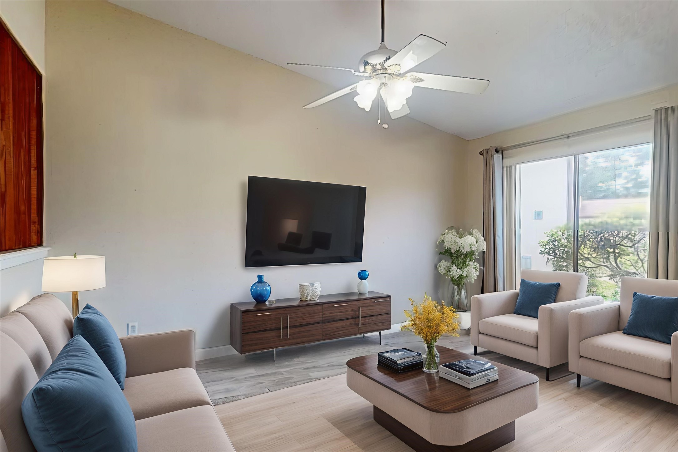 7840 Bateman Lane Houston, TX 77088 - Photo 3 of 25 a living room with furniture a flat screen tv and a large window