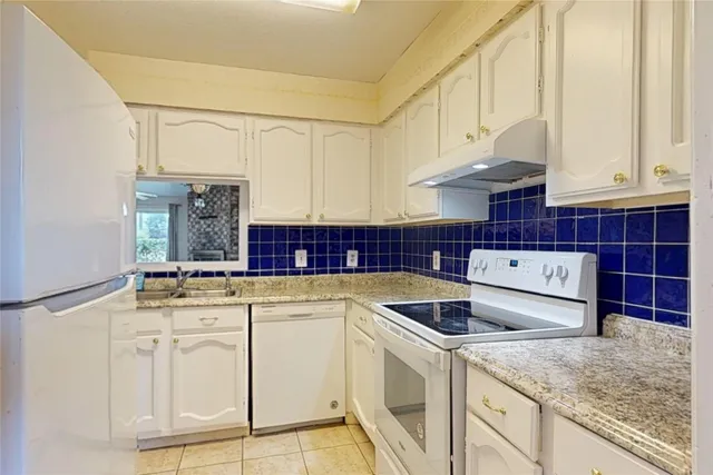 a kitchen with stainless steel appliances granite countertop a sink and cabinets