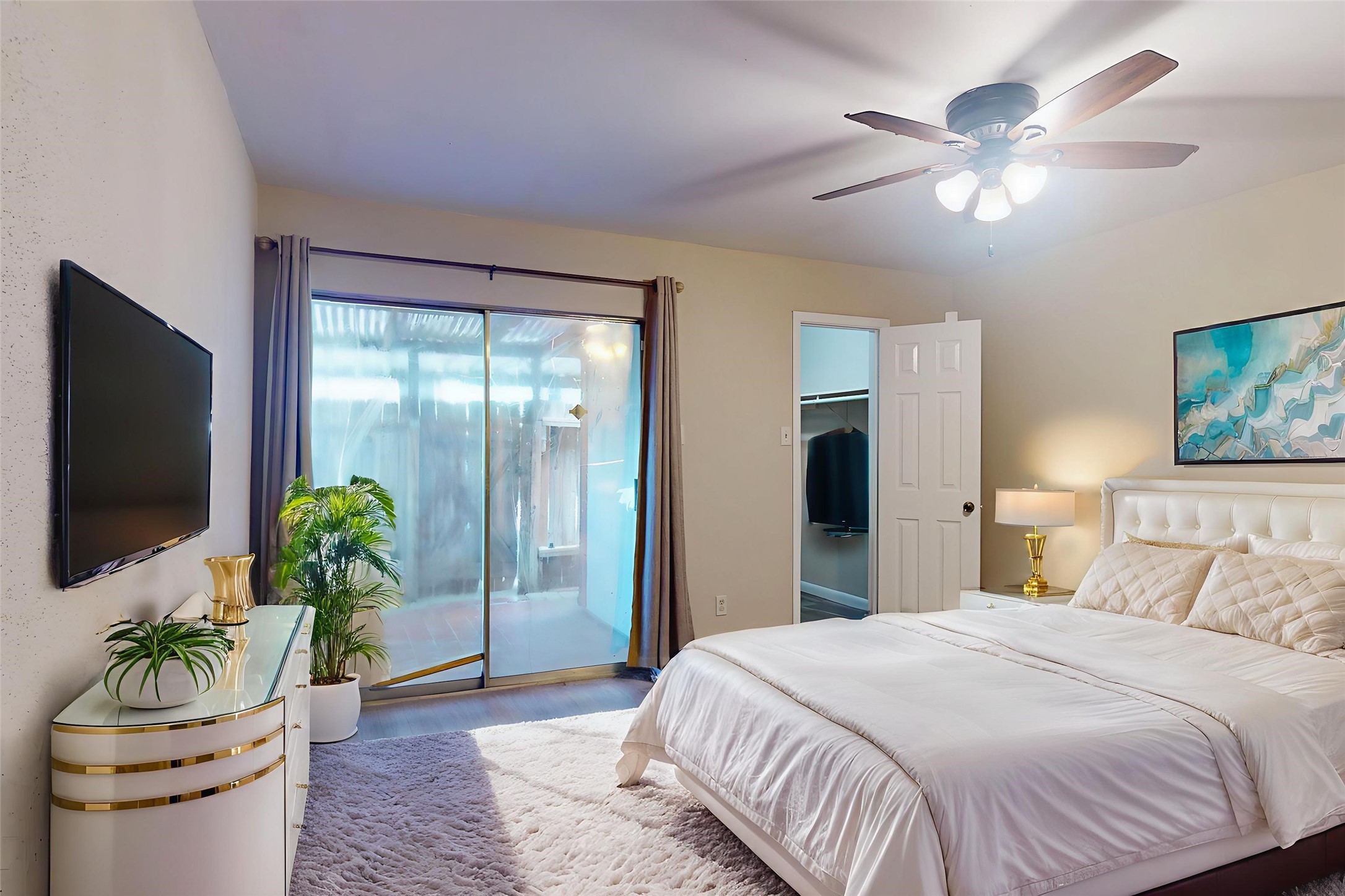 7840 Bateman Lane Houston, TX 77088 - Photo 7 of 25 a bedroom with a bed and a chandelier