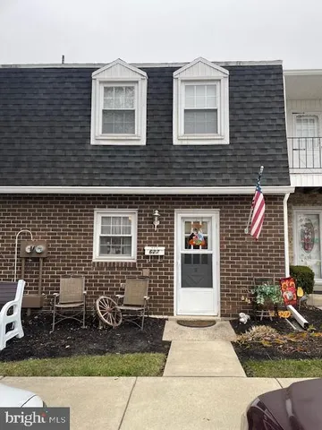 a view of a brick house with many windows