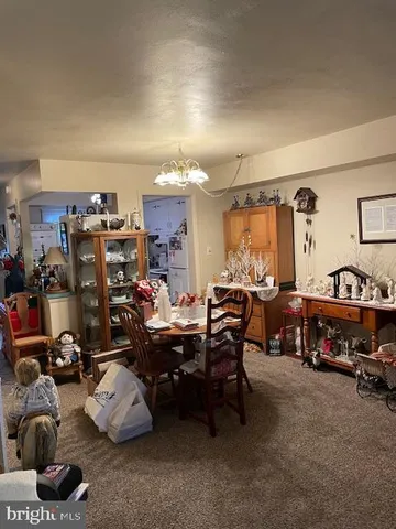 a living room with lots of furniture and a chandelier