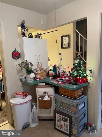 a utility room with stainless steel appliances granite countertop a sink and cabinets