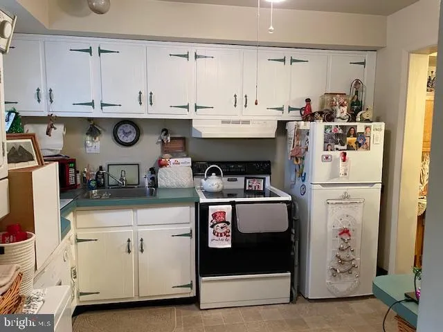 a kitchen with cabinets and window